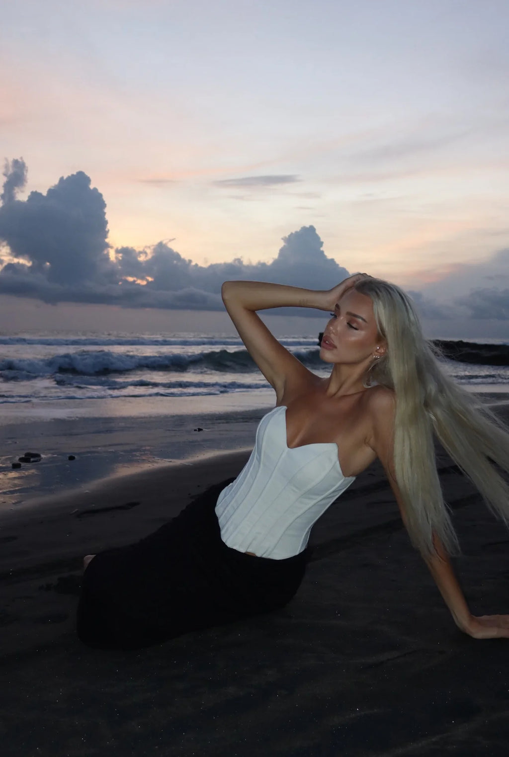 Cream sculpted corset from Solana, shown in a close-up sunset shot highlighting the structured paneling and sweetheart neckline.