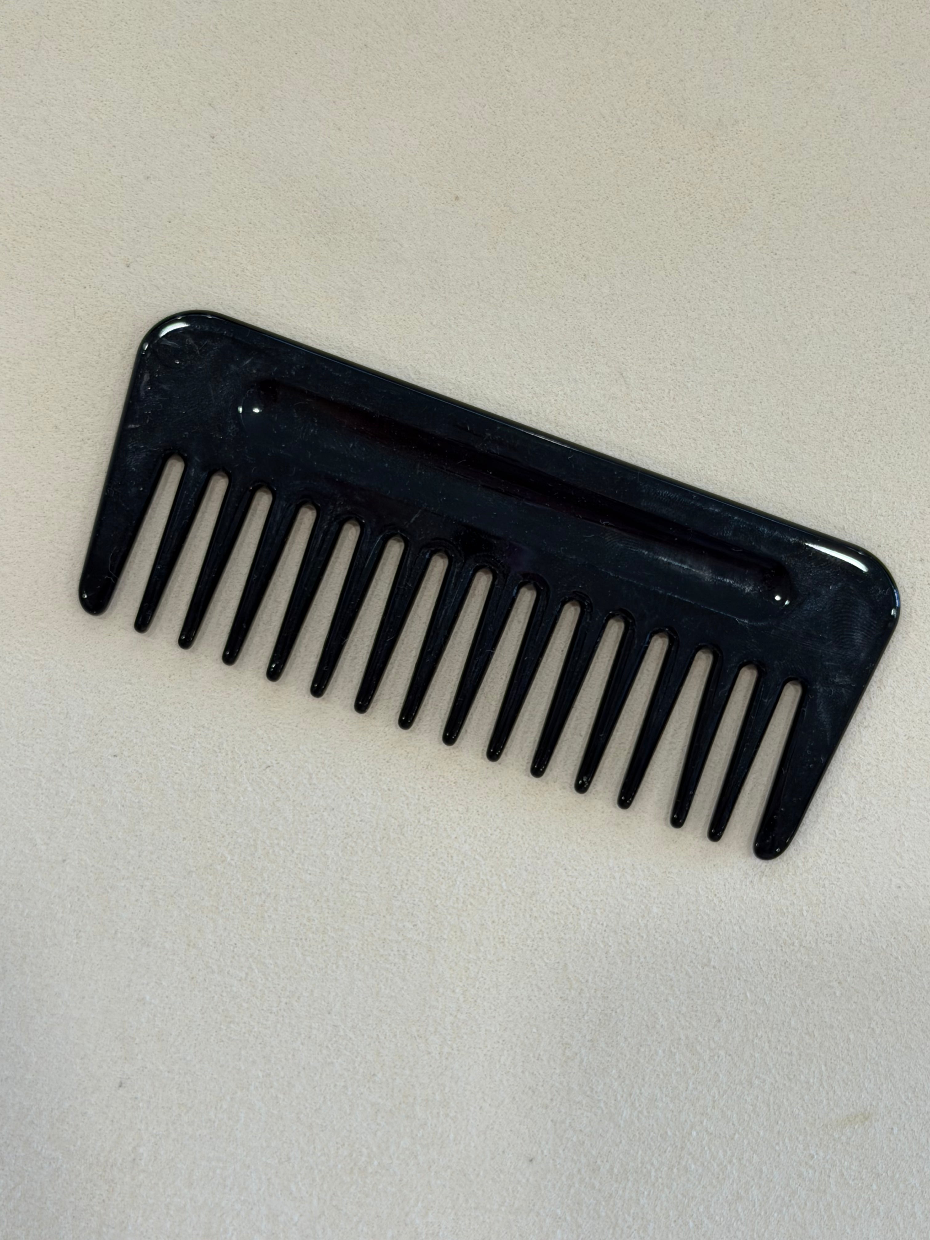 Black comb on a beige background