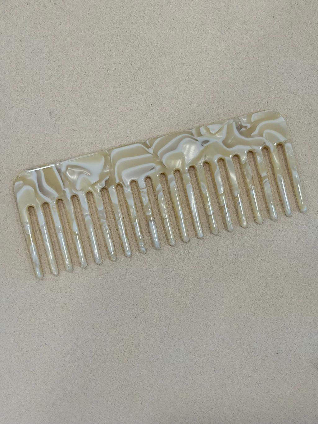 Decorative comb with shell pattern on a beige background