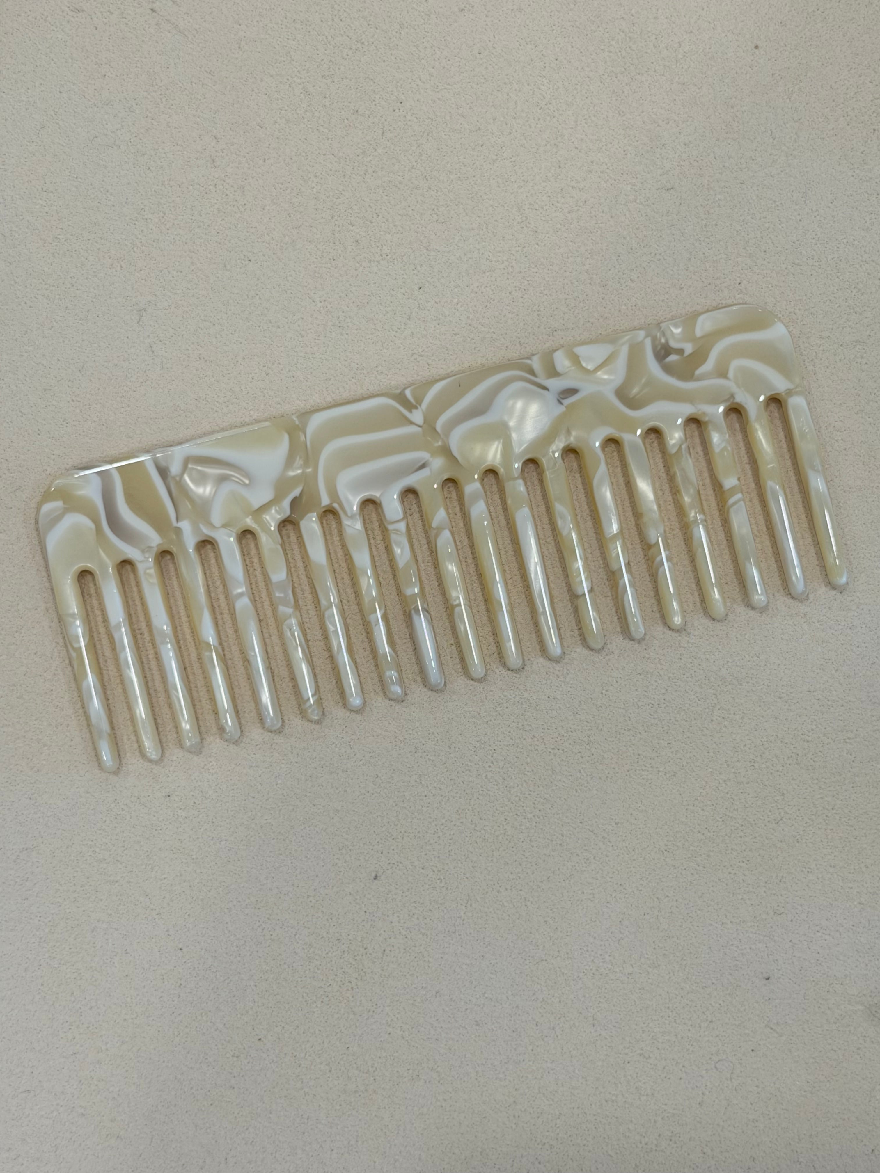 Decorative comb with shell pattern on a beige background